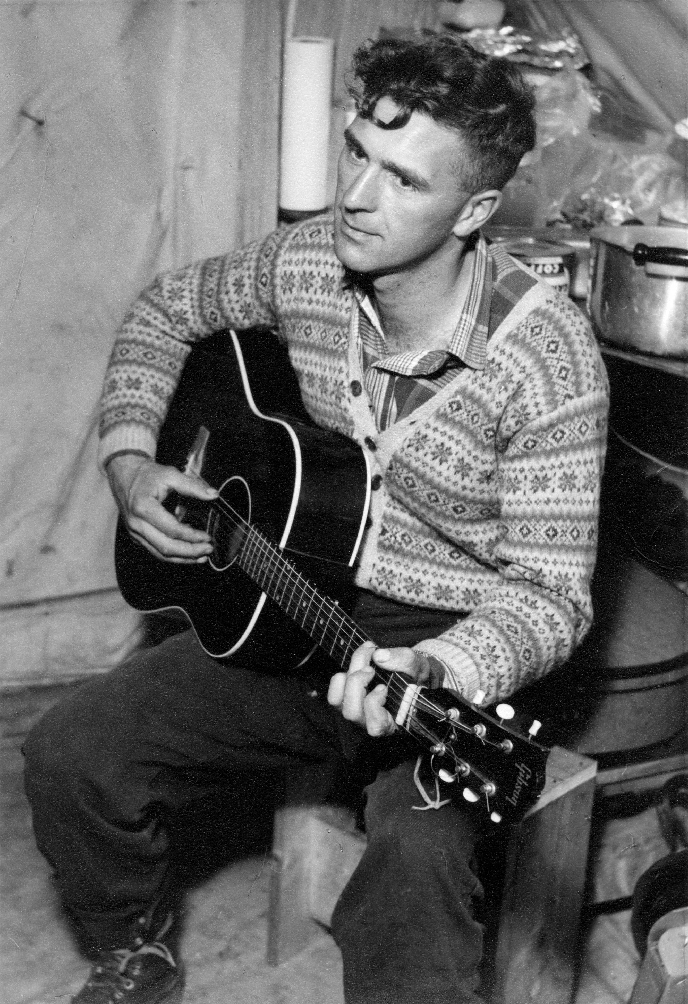 Keith Crowe strumming his guitar in 1960