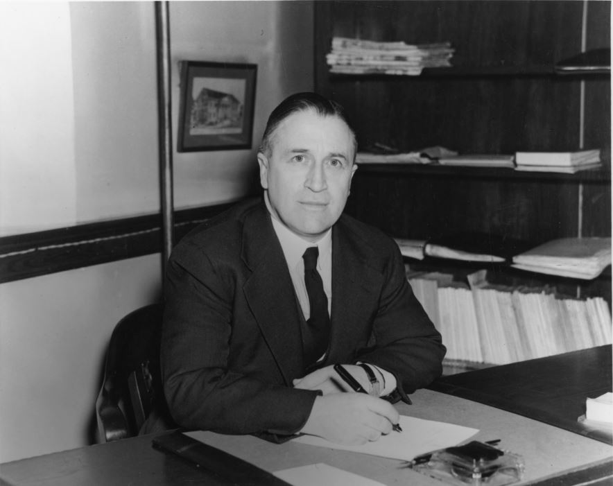 Photograph of A.E. Kerr, President, 1945-63, in his office in the Macdonald Library.