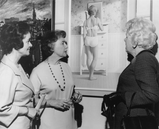 Photograph of Pat Nicholls, Gene Hicks and Kathy Weld viewing painting “Woman with a slip” by Christopher Pratt